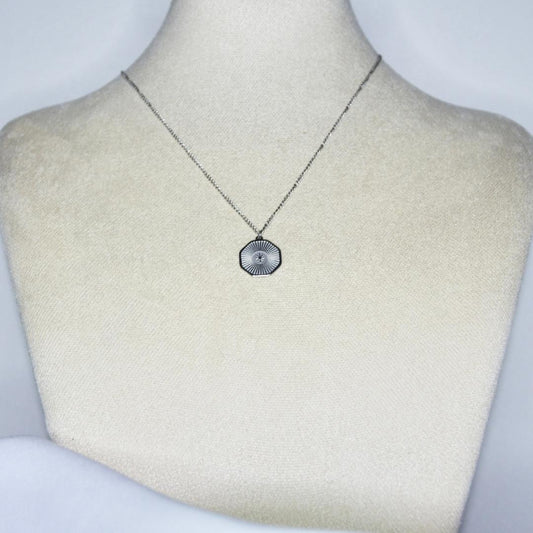 Collier modèle Shine Necklace en argent avec pendant rayonnant sur présentoir