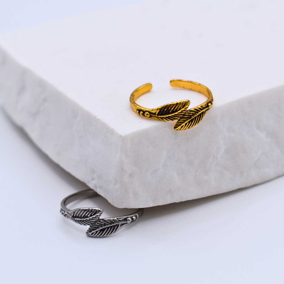 Bagues modèle Feather Ring en or et en argent sur support