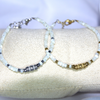 Bracelets modèle Tears White blanc et argent blanc et doré sur présentoir