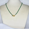 Collier modèle La Ciotat Necklace en perles vertes avec fermoir bouée en or sur présentoir